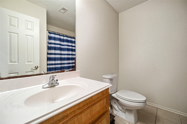 bathroom featuring toilet, visible vents, baseboards, vanity, and tile patterned floors