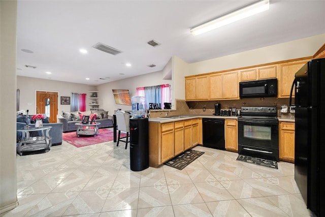 kitchen featuring a peninsula, visible vents, open floor plan, light countertops, and black appliances