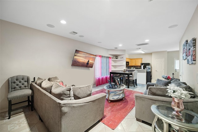 living area featuring light tile patterned floors, visible vents, and recessed lighting