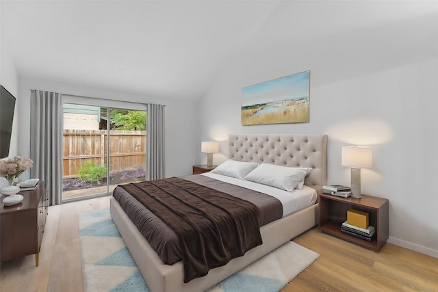 bedroom featuring vaulted ceiling, baseboards, and wood finished floors