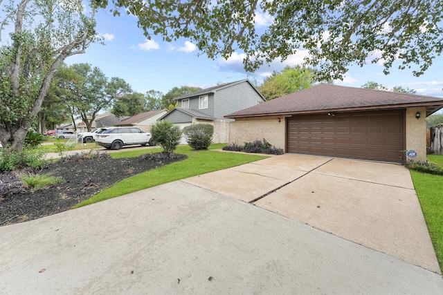 view of front of home with an attached garage, a front lawn, concrete driveway, and roof with shingles