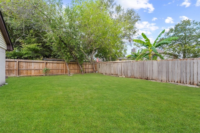 view of yard with a fenced backyard