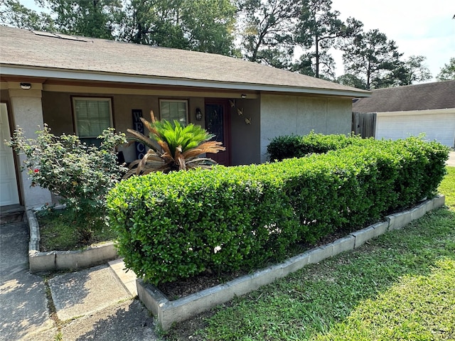 view of front of home with a garage and stucco siding