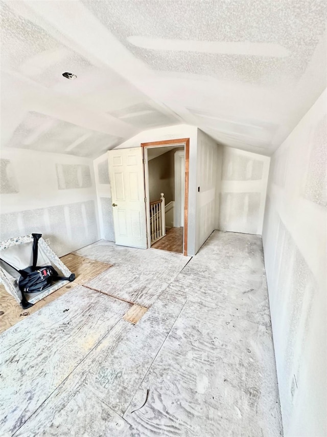 spare room with vaulted ceiling and a textured ceiling