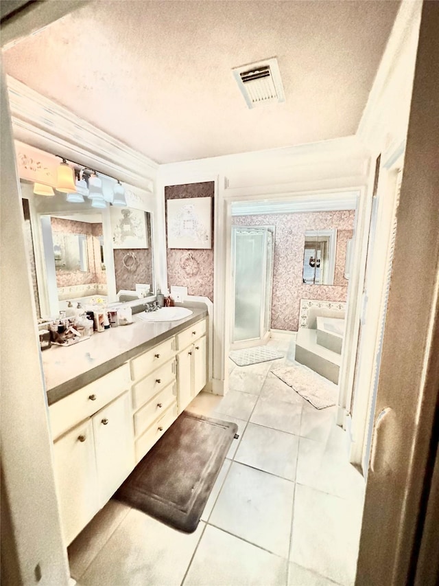 bathroom featuring a shower stall, visible vents, a textured ceiling, and vanity