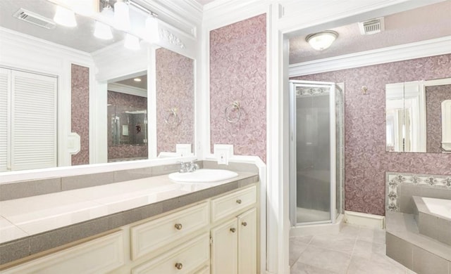 bathroom featuring ornamental molding, a stall shower, visible vents, and wallpapered walls