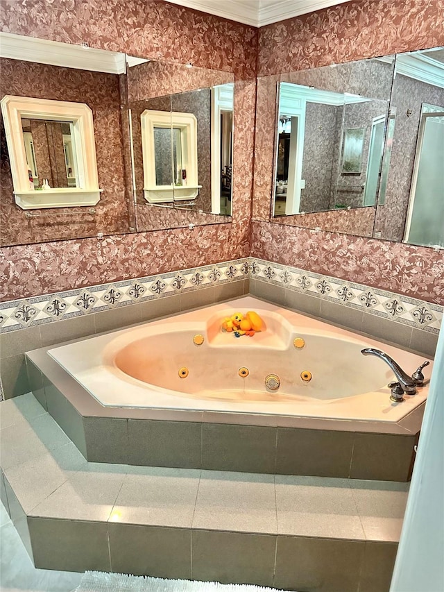 bathroom with a whirlpool tub and ornamental molding