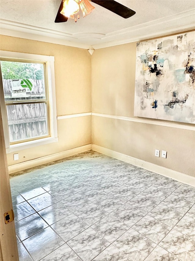 empty room with a textured ceiling, baseboards, and a ceiling fan