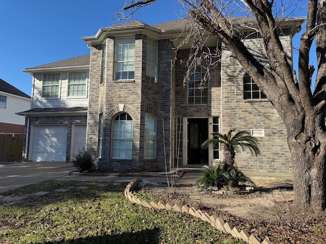 view of front of property with an attached garage, concrete driveway, and brick siding