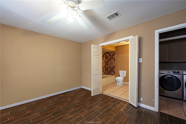 unfurnished room with ceiling fan, visible vents, baseboards, wood tiled floor, and washer / clothes dryer