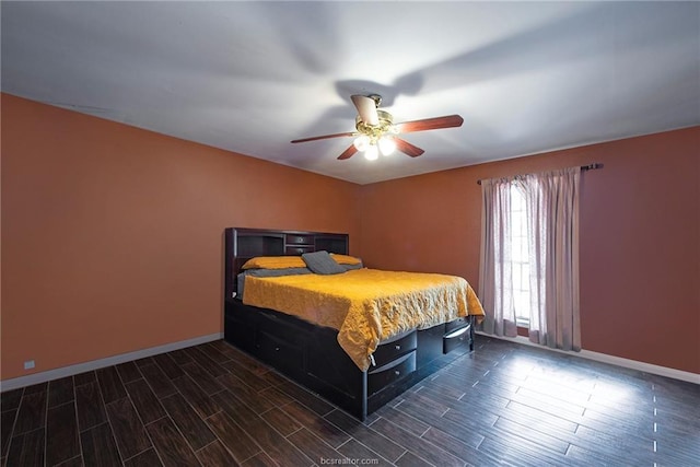 bedroom with wood finish floors, a ceiling fan, and baseboards