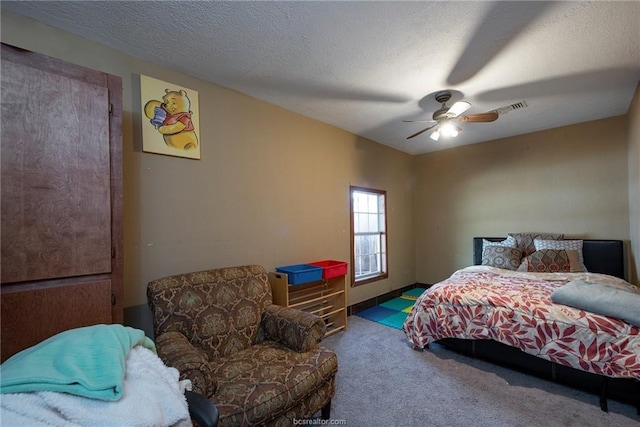 carpeted bedroom with visible vents, ceiling fan, and a textured ceiling