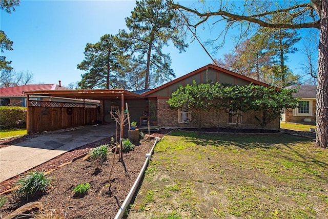 view of front of house featuring a carport, a front lawn, concrete driveway, and brick siding