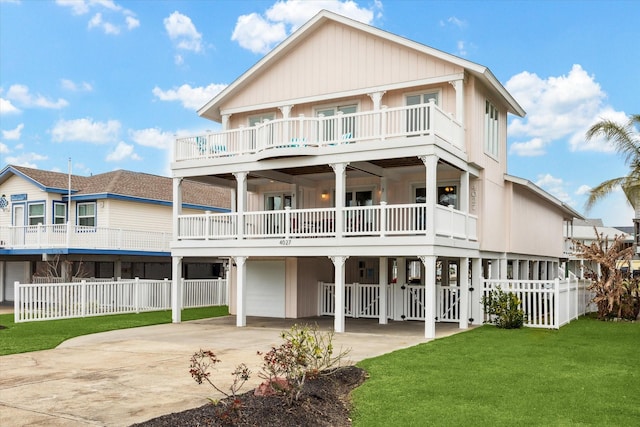 back of property featuring a carport, a lawn, driveway, and fence