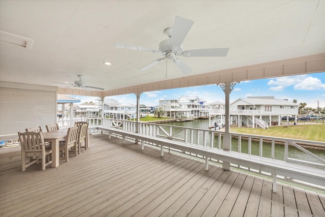 dock area with a residential view, a water view, and outdoor dining space