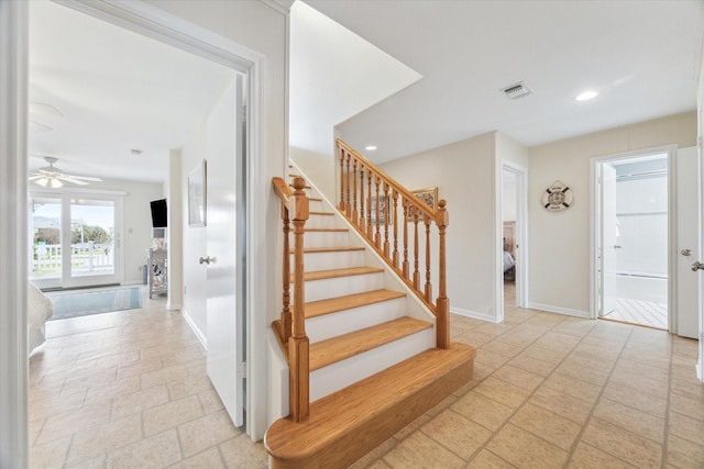 stairs with baseboards, visible vents, stone tile floors, and recessed lighting