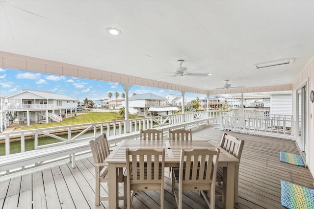 deck with a water view, a residential view, and a ceiling fan