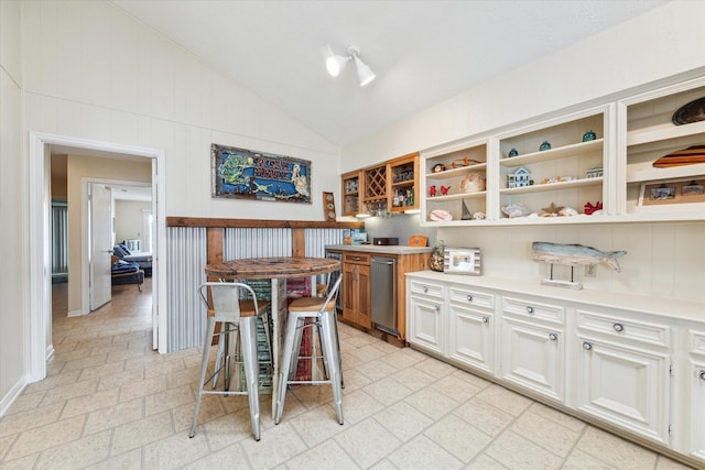 kitchen with open shelves, vaulted ceiling, and light countertops