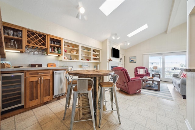 bar with wine cooler, a fireplace, a dry bar, high vaulted ceiling, and dishwasher