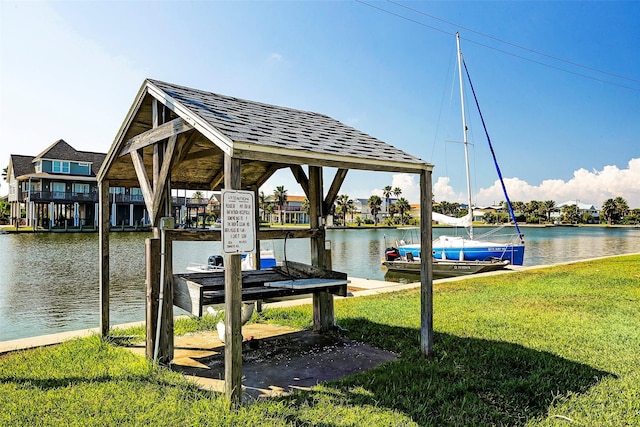 4027 Nueces Dr, Galveston, TX 77554 - dock area featuring a water view and a lawn
