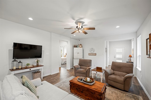 living area with a ceiling fan, recessed lighting, baseboards, and wood finished floors