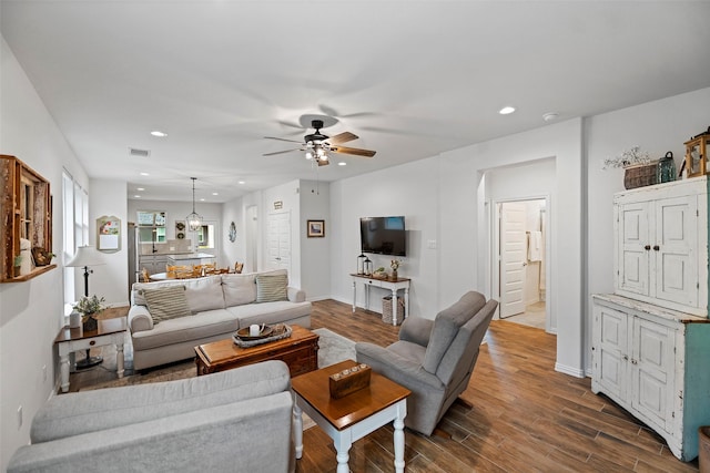 living room featuring dark wood-style floors, recessed lighting, visible vents, and a ceiling fan