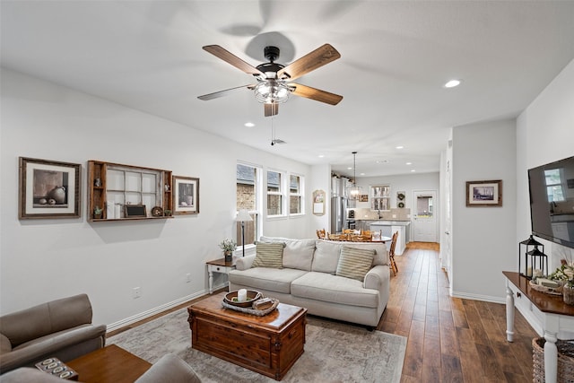 living room with a ceiling fan, recessed lighting, dark wood-style flooring, and baseboards