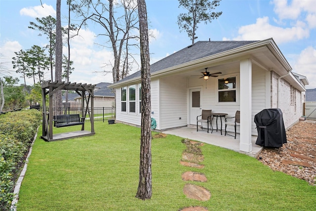 back of property with a patio, fence, a ceiling fan, a lawn, and a pergola