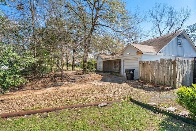 view of yard with a garage and fence