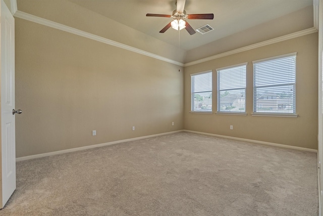 spare room featuring ornamental molding, light colored carpet, visible vents, and baseboards