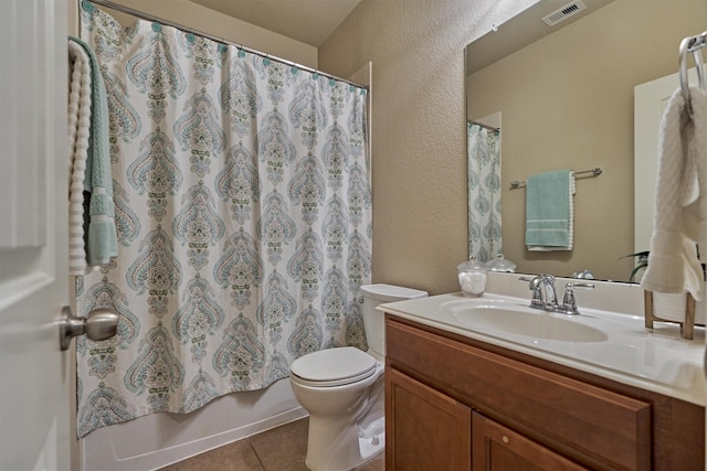 bathroom featuring visible vents, toilet, tile patterned floors, shower / bath combination with curtain, and vanity