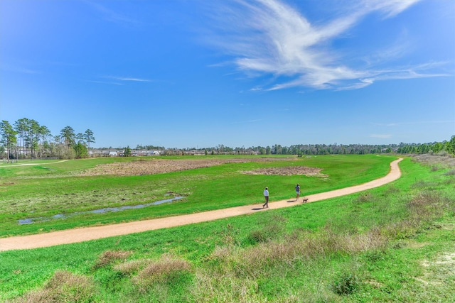 surrounding community featuring a lawn and a rural view