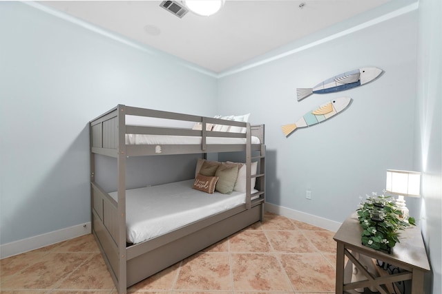 bedroom featuring light tile patterned floors, visible vents, and baseboards