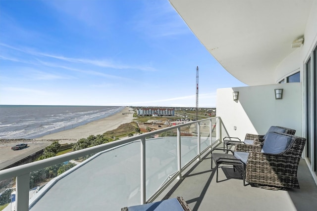 balcony with a water view and a beach view