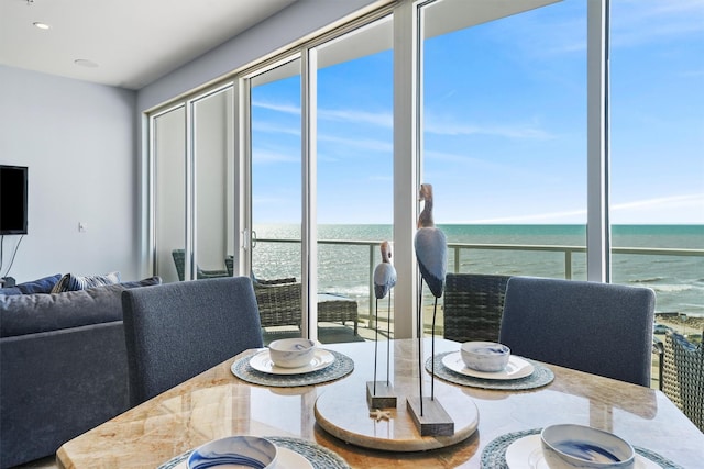 dining space featuring recessed lighting and a water view