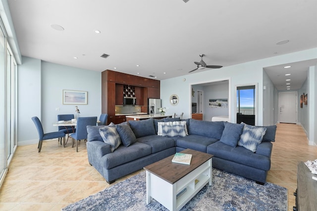 living room featuring a ceiling fan, recessed lighting, a wealth of natural light, and light tile patterned flooring