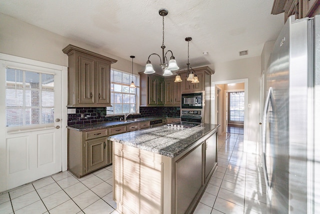 kitchen with decorative backsplash, light tile patterned flooring, a sink, a kitchen island, and black appliances