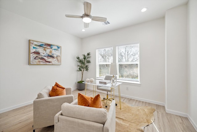 office featuring light wood-type flooring, visible vents, and baseboards