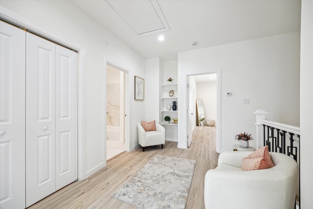 living area with baseboards, light wood-type flooring, an upstairs landing, and recessed lighting