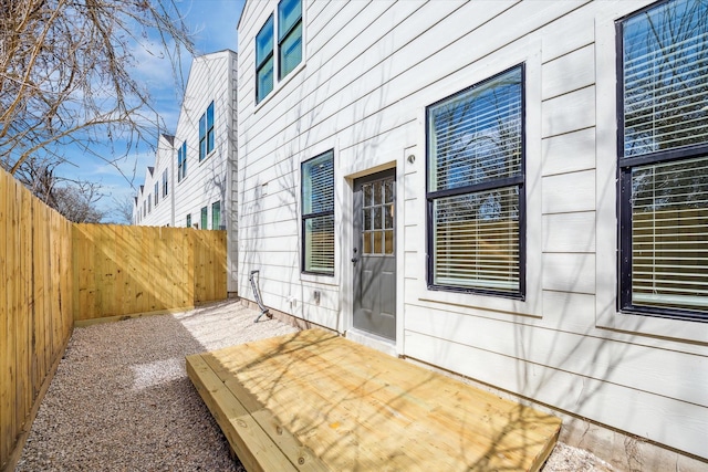 view of side of home with a fenced backyard and a wooden deck