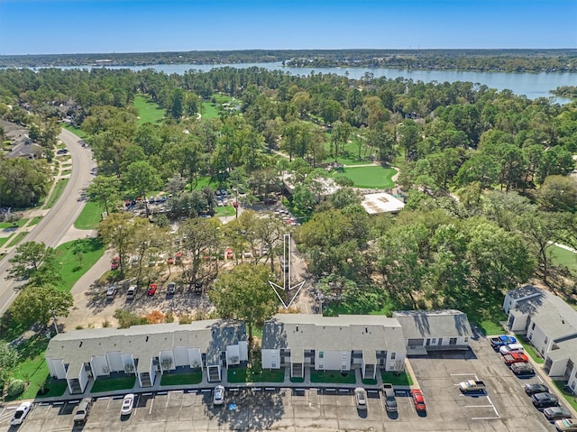 birds eye view of property with a water view and a view of trees