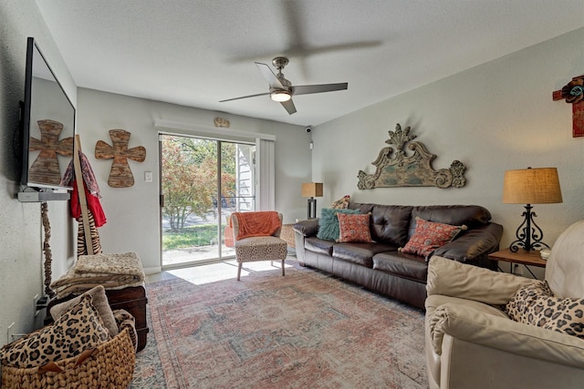 living room with a textured ceiling and a ceiling fan