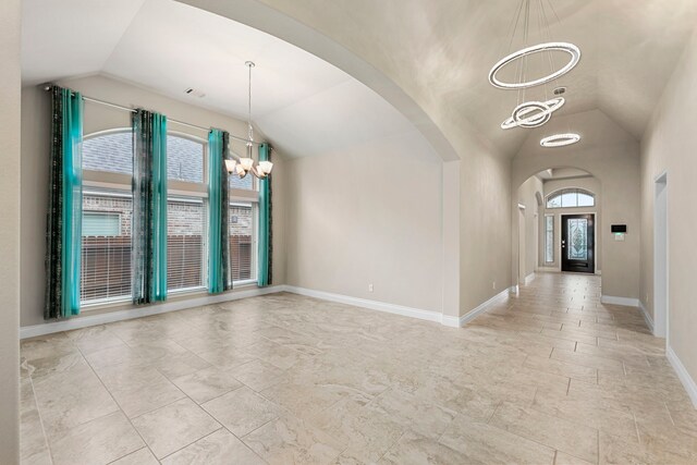 5615 Alexan Crest Dr, Fulshear, TX 77441 - entryway with vaulted ceiling, arched walkways, a chandelier, and baseboards