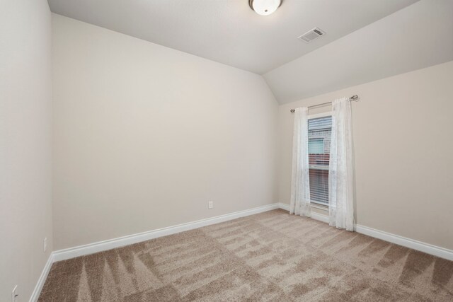 5615 Alexan Crest Dr, Fulshear, TX 77441 - spare room with light carpet, baseboards, and vaulted ceiling