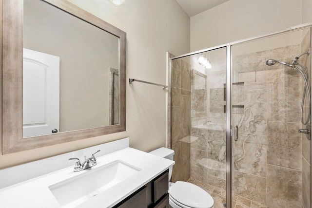 bathroom featuring a stall shower, vanity, and toilet