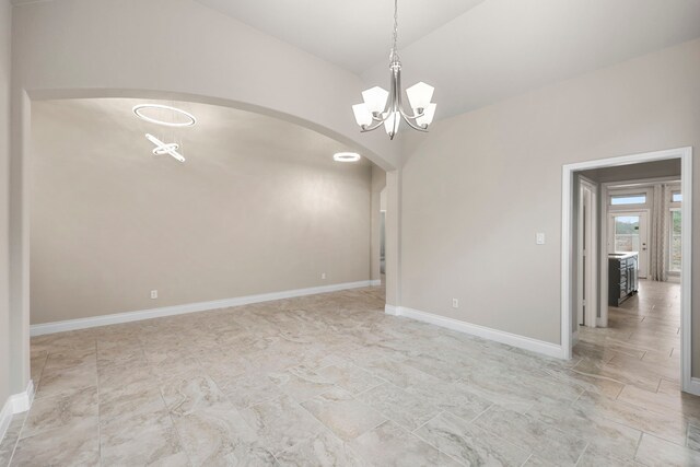 5615 Alexan Crest Dr, Fulshear, TX 77441 - unfurnished room with arched walkways, a chandelier, baseboards, and vaulted ceiling