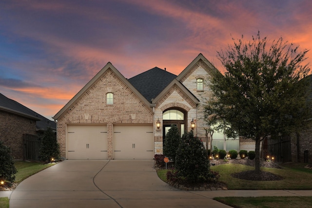 5615 Alexan Crest Dr, Fulshear, TX 77441 - french country inspired facade featuring driveway, brick siding, and stone siding