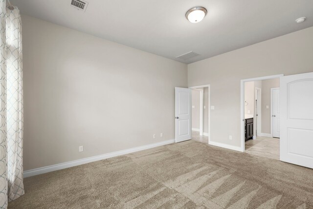 5615 Alexan Crest Dr, Fulshear, TX 77441 - unfurnished bedroom featuring light carpet, baseboards, and connected bathroom