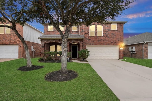 traditional-style house with concrete driveway, brick siding, a lawn, and an attached garage