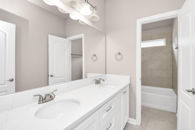 full bath with double vanity, tile patterned flooring, and a sink